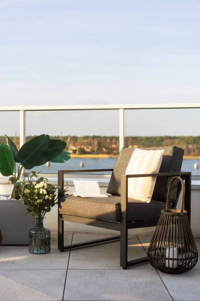 istock Chair with book on rooftop terrace, against water view 2180973475