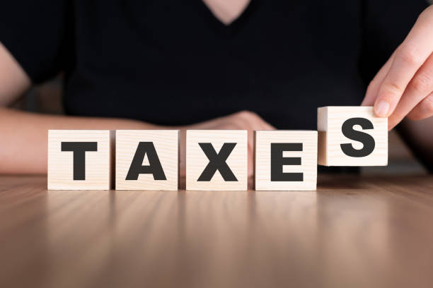 istock Taxes word with wooden blocks on table 2180973944