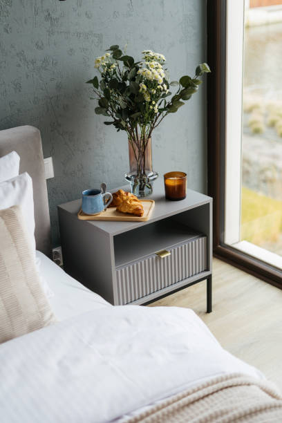 istock Breakfast tray croissant and morning coffee on bedside table near bed 2180975077