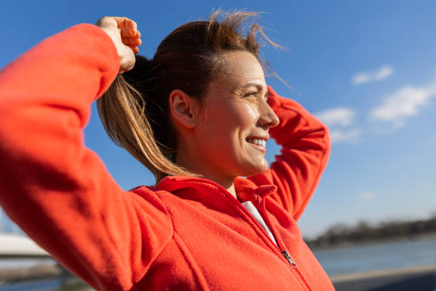 istock Woman Prepares by Tying Her Hair 2180975661