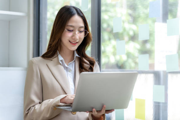 istock Happy young business woman working on her project at the office 2180975915