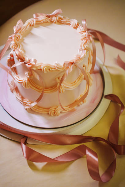 istock A beautiful birthday cake with cream and ribbons. 2180978138