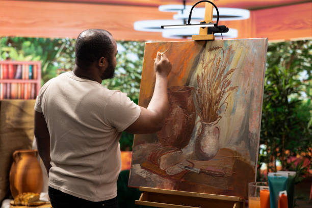 istock African american artist using his skill to paint a new creation in art studio 2180982645