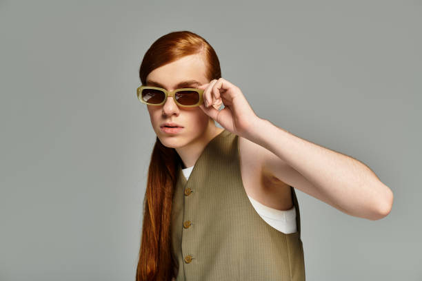 Red-haired teen shows off his unique style in a trendy studio