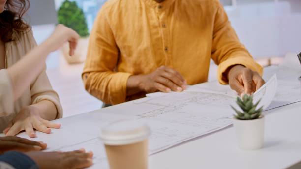 istock real estate agent and clients exploring an urban property financial potential 2180983320