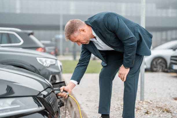 istock Mid Adult Man Engages in Electric Car Charging 2180983556