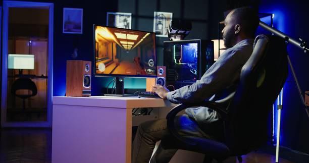 istock Man arriving at home to play videogames on gaming PC at computer desk 2181003508