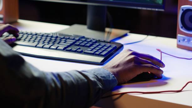 istock Keyboard and mouse used by gamer competing in online multiplayer videogame 2181005494