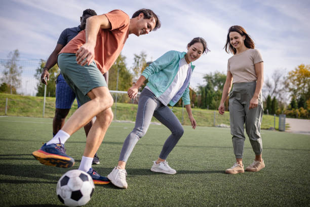 istock Friends in action having fun on a grassy soccer field 2181005629