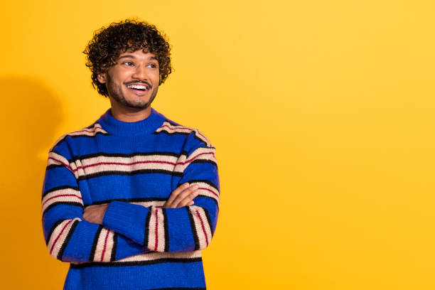 istock Photo of handsome young guy crossed hands confident look empty space dressed blue striped garment isolated on yellow color background 2181005704