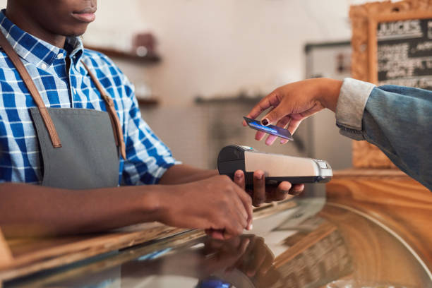 istock Cafe customer paying for her purchace with nfc technology 2181005919