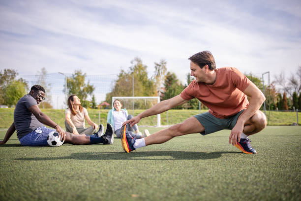 A soccer team stretches together on a field, instilling a sense of unity, fitness, and team spirit in a vibrant setting, gearing up for an upcoming game.