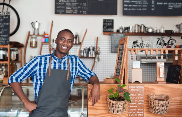 istock Smiling barista leaning on the counter in a cafe 2181006804
