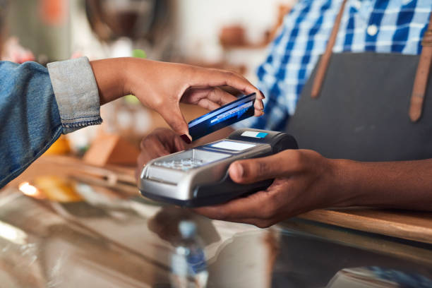 istock Customer paying for her cafe purchace with nfc technology 2181007047
