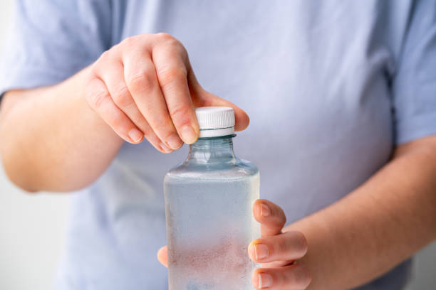 istock woman opening plastic bottle with 2181007112
