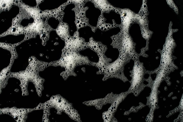 istock Texture of white foam on a black background. 2181008015