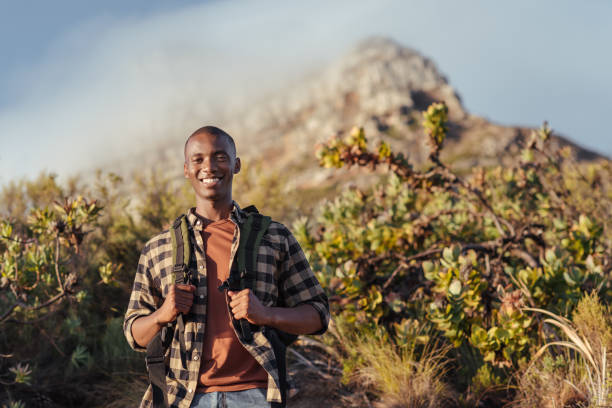 istock Smiling young African man enjoying a trek in the mountains 2181008499