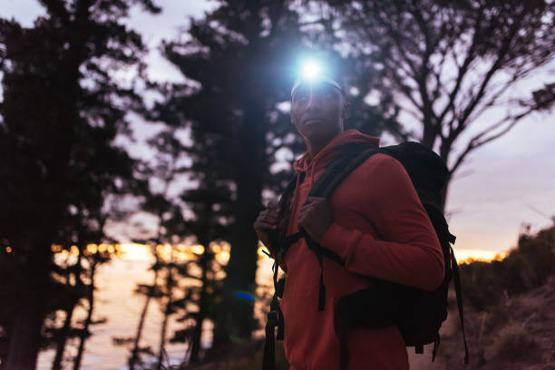 istock Young African man hiking alone in the woods at dusk 2181008721