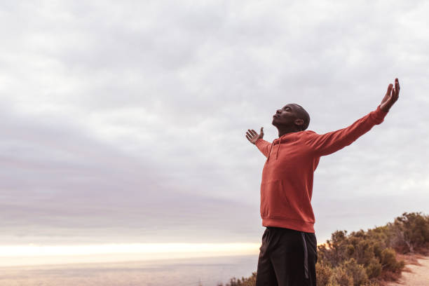 istock Young African man standing on a trail outside embracing nature 2181009118