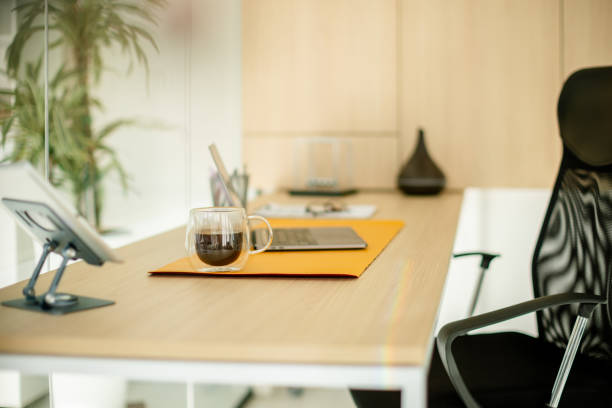 istock Sleek office desk with laptop and coffee mug 2181010204
