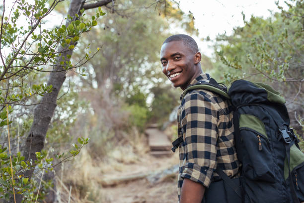 istock Smiling young African man hiking in the hills 2181010251