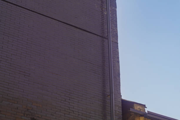 Old brick building with a prominent external ventilation duct system