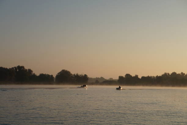 istock Boats sailing on river in the morning hours. 2181011712