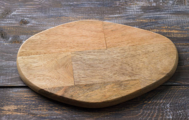 istock Empty wooden cutting board on wooden background, mockup for creative design 2181011773