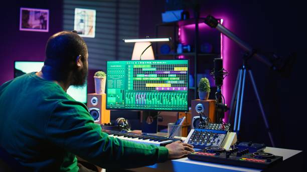 istock Audio composer playing piano electronic keyboard to create a new track 2181012949