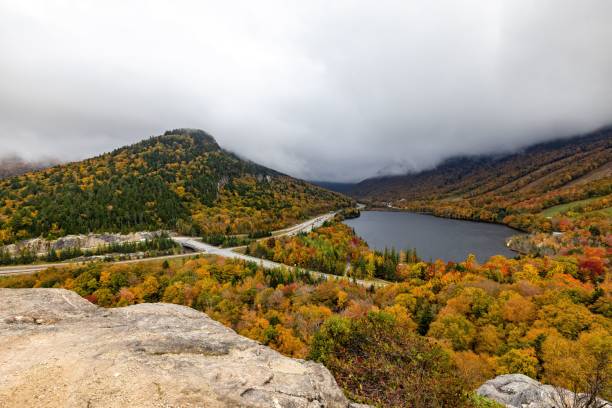 istock Winding road snakes through a mountainous forest landscape 2181014080