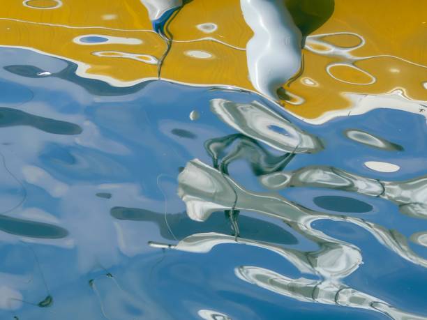 The reflections on the surface of the water create an abstract image.