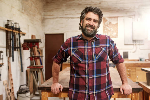 istock Smiling bearded craftsman in his woodwork studio 2181015211
