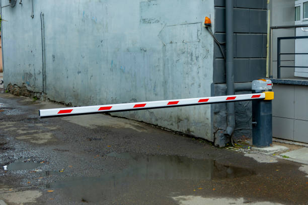 istock A security barrier blocking vehicle access in a narrow alley during a rainy day 2181015718