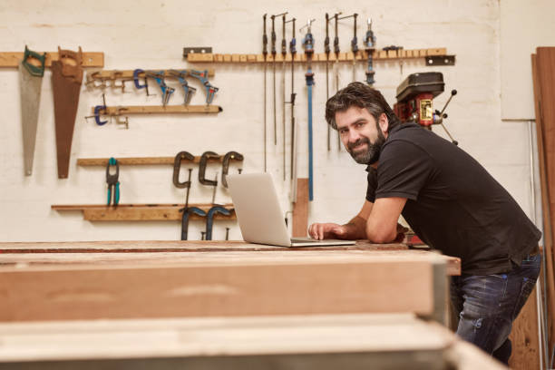 istock Woodwork artisan in his workshop studio with a laptop 2181015742