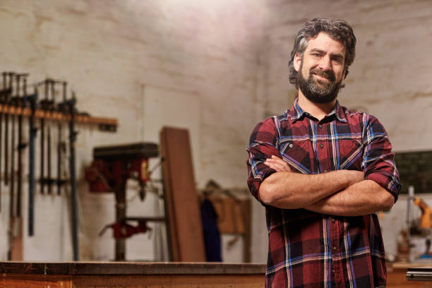 istock Small carpentry business owner smiling with arms crossed 2181016230