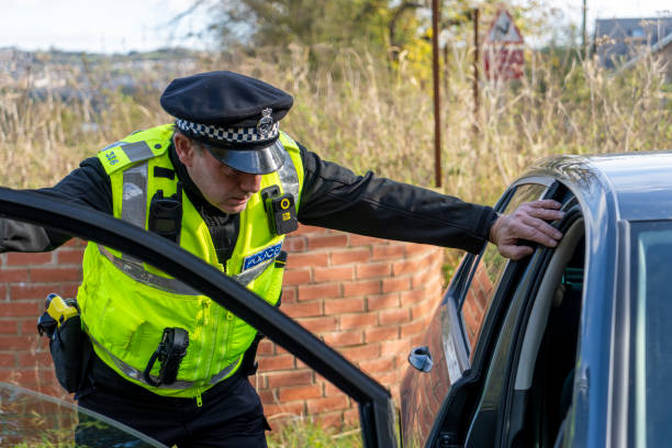 istock UK police officer approaching a parked car 2181016845