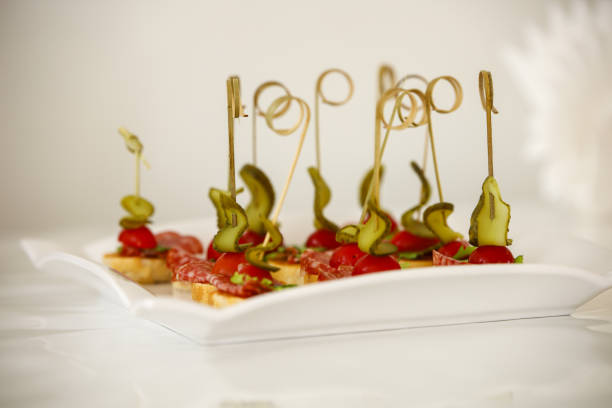 Light vegetable appetizer with smoked sausage and vegetables, strung on skewers
