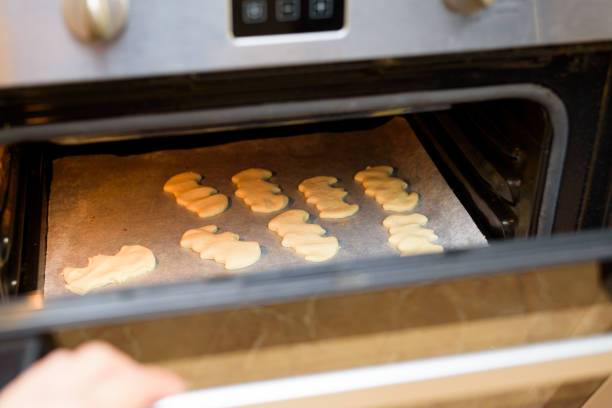 istock Baking halloween bat shaped cookies in electric oven 2181018876