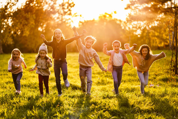 istock A group of children running on a meadow 2181019447