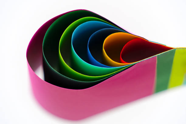 Top view of bend paper sheets in different colors against white background. Photo taken October 25th, 2024, Zurich, Switzerland.