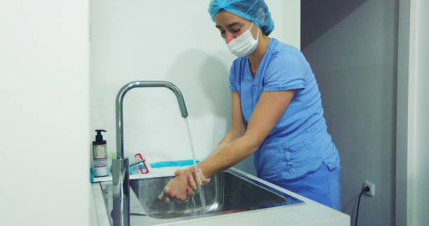 istock Female Surgery Specialist Washing Hands Before Operation For Sterile Work 2181020715