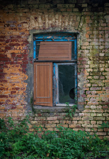 istock Old wooden rustic window on the ancient abandoned house 2181024876