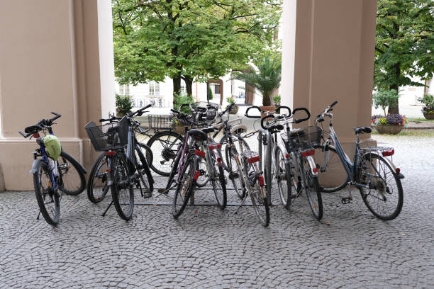 Close-up shot  Group of Bicycles Parked in front of a building. Concept: city bikes, bicycle parking, urban transportation, eco-friendly commuting, sustainable mobility, parked bicycles, outdoor lifestyle, city architecture, community bikes, group parking, street view, active lifestyle, environmentally friendly