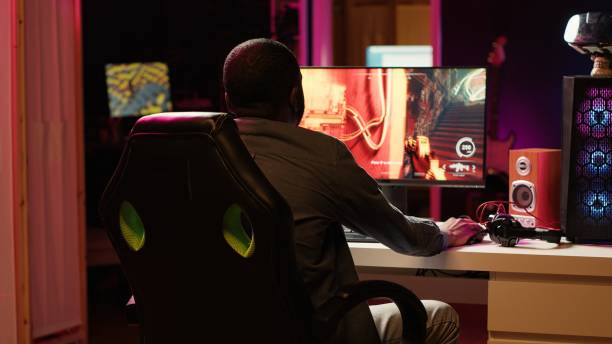istock Man filming himself while playing on gaming PC, welcoming audience 2181027675