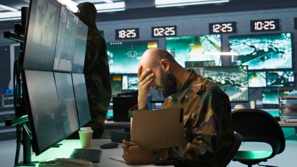 istock Tired military officer reading intel folder on enemy, feeling fatigued 2181031286