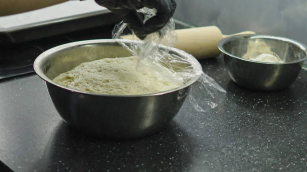 istock Yeast dough under foil. Cooking process. Preparation of yeast dough 2181032719