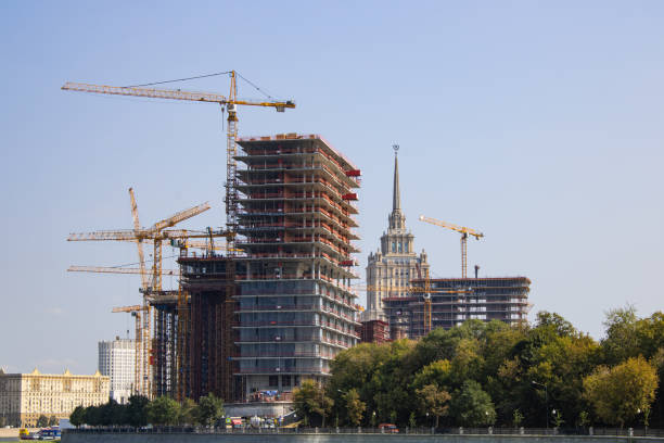 Construction site. Tower cranes in action. Formwork and concrete pouring.