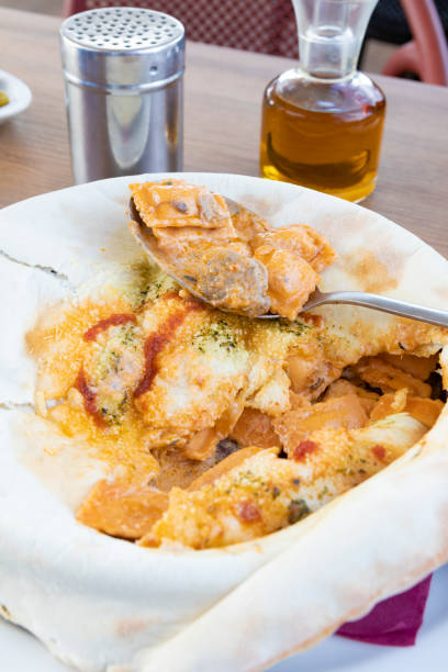 Pot of Boiling Ravioli on Stove, Wood Spoon On Top