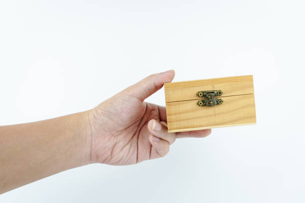 istock hand holding small wooden box on white background. 2181039045