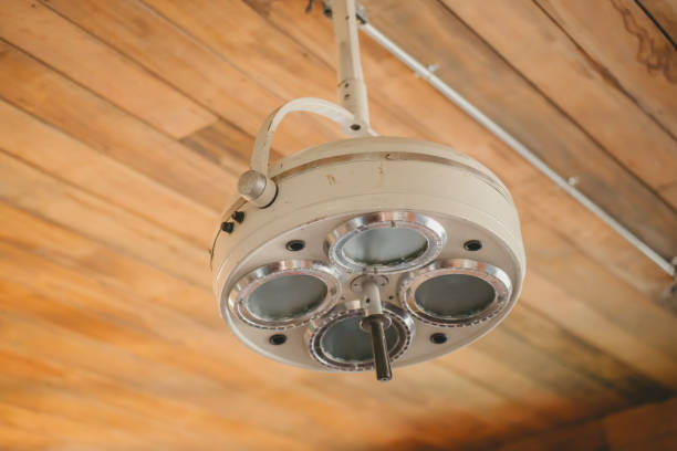 An old fashioned medical lamp hangs from the ceiling.